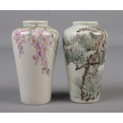 483 - A pair of miniature Chinese high shouldered vases, hand painted with flowers and trees. Height 9cm.