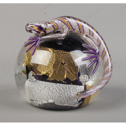 507 - A Twists Glass studio paperweight of spherical form, topped by a lizard or purple, gold and silvered... 