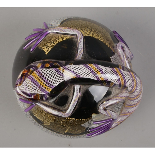 507 - A Twists Glass studio paperweight of spherical form, topped by a lizard or purple, gold and silvered... 