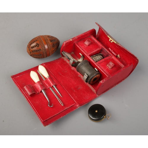 515 - A Frank Smythson of New Bond Street red leather pocket sewing kit, fitted with contents.