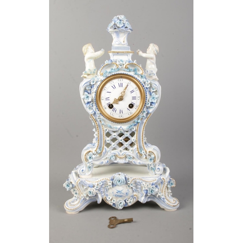 84 - A Nineteenth Century French blue and white ceramic mantle clock on stand, depicting two cherubs surr... 