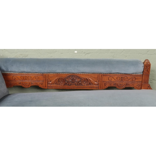 532 - A Victorian oak chaise longue, with carved detailing to the front scrolling and back plate; having p... 