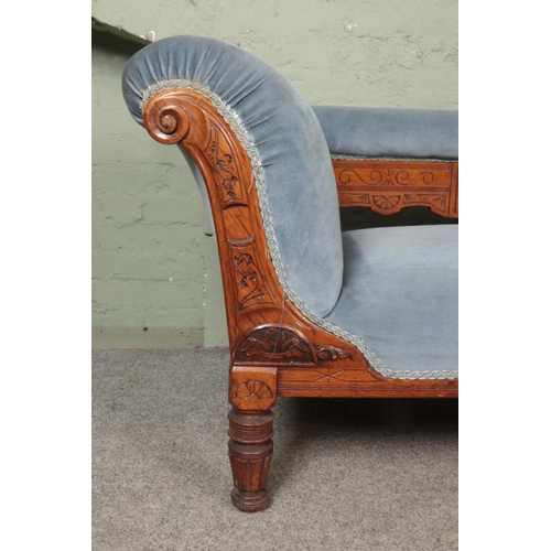 532 - A Victorian oak chaise longue, with carved detailing to the front scrolling and back plate; having p... 