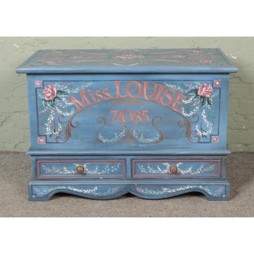 534 - A painted pine mule chest with hinged top and two lower drawers. Featuring all over floral detailing... 