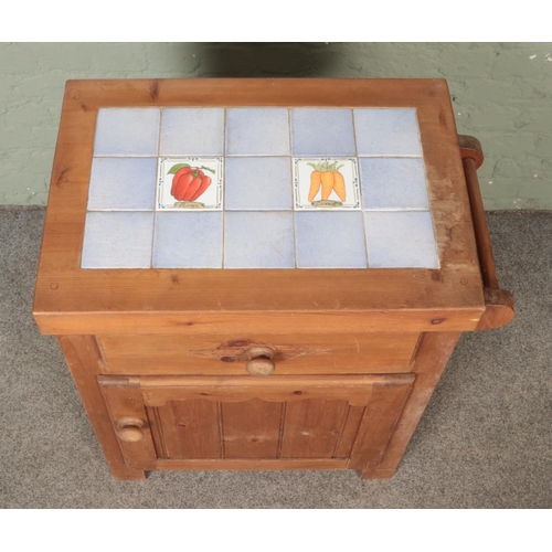 535 - A small pine kitchen unit, with tiled top. Height: 82cm, Width: 74cm, Depth: 47cm.