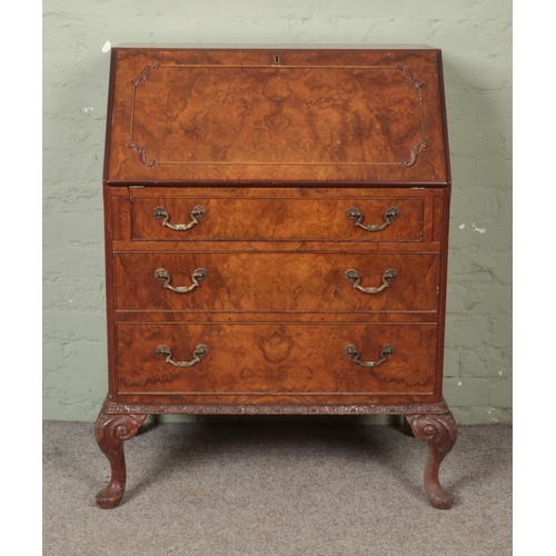 536 - A walnut writing bureau, with fall down front over three drawers. Height: 103cm, Width: 76cm, Depth:... 