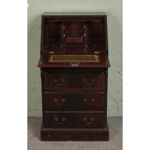 538 - A mahogany bureau of slender proportions, with drop down top revealing fitted interior, below four d... 