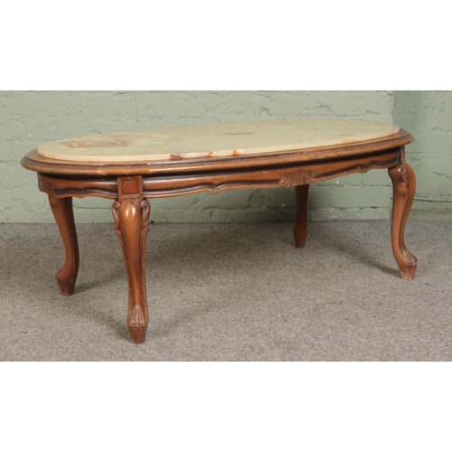 541 - An onyx topped coffee table, on wooden base with carved cabriole supports. Height: 44cm, Width: 111c... 