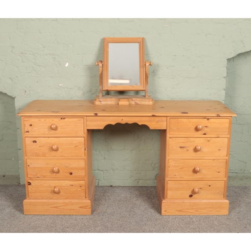 546 - A pine twin pedestal dressing table/desk with pine mirror.