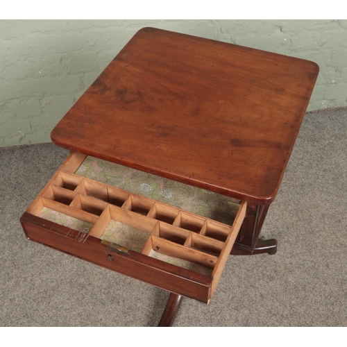 547 - A mahogany work box with two drawers and matched faux drawers to each side standing on triform pedes... 