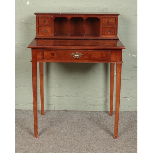 551 - A mahogany ladies writing desk, topped with a bank of drawers and storage pigeon holes. Height: 96cm... 