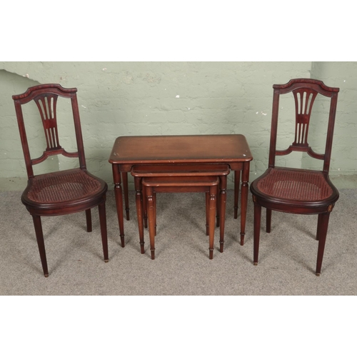 558 - A pair of French empire style side chairs along with nest of tables.