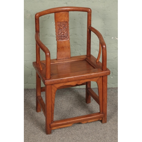 562 - An oriental hardwood chair with carved back splat.