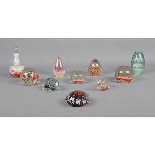 9 - Ten assorted glass paperweights, to include Mdina, Victorian dump, animal and millefiori examples.