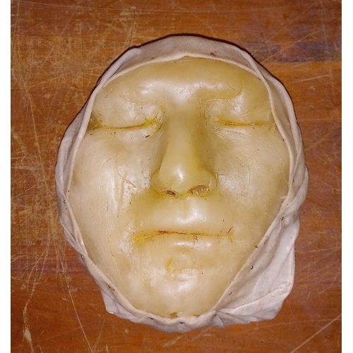 485 - Two late Victorian wax death masks, possibly French, to include example partially wrapped in waxed f... 