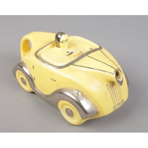 145 - An Art Deco Sadler novelty racing car teapot in yellow with chrome detailing. Number plate OKT42. Le... 