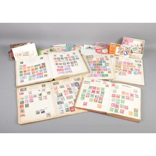 110 - A collection of partly filled stamp albums, together with two tins of loose stamps. Contains Great B... 