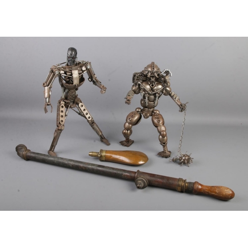 135 - Two scrap metal built models including Terminator and Predator examples together with a gunpowder fl... 