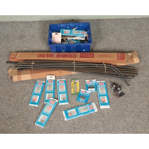 163 - A collection of mostly Peco model railway 00 gauge track and accessories to include turnout motors a... 