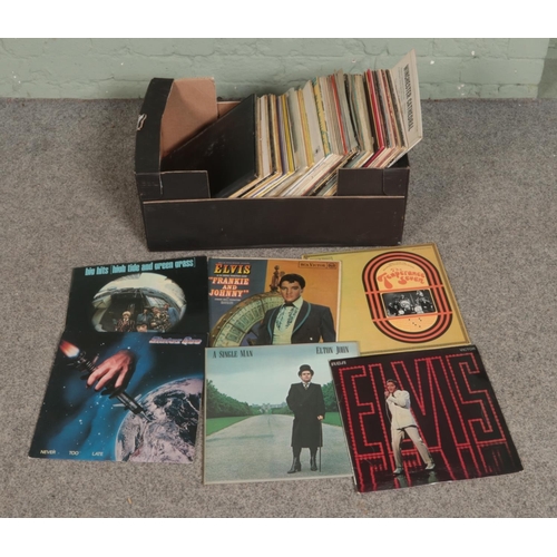 186 - A large quantity of records including Elvis, The Rolling Stones, Status Quo, Elton John, The Tempera... 