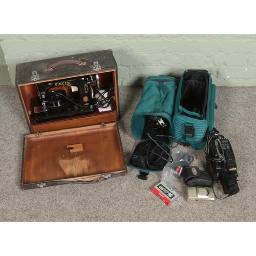 217 - A cased Singer 99k sewing machine along with a Canon E250 camcorder and Olympus Zoom 105 camera.