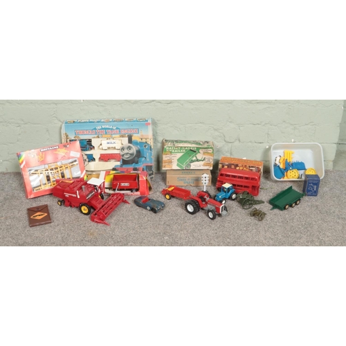 232 - A collection of assorted scale model vehicles, to include Britains Massey Ferguson combine harvester... 