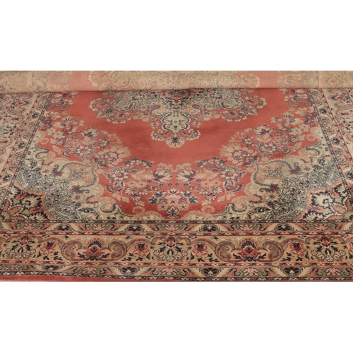 278 - A large ground wool rug featuring central floral medallion and fringed edges. Approx. width 280cm.