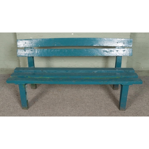 292 - A painted garden bench, with cast iron supports. Length: 145cm.