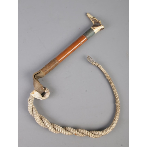 54 - A bone handled shepherd's cane; the handle formed as a dog's head with whistle, featuring twisted ro... 