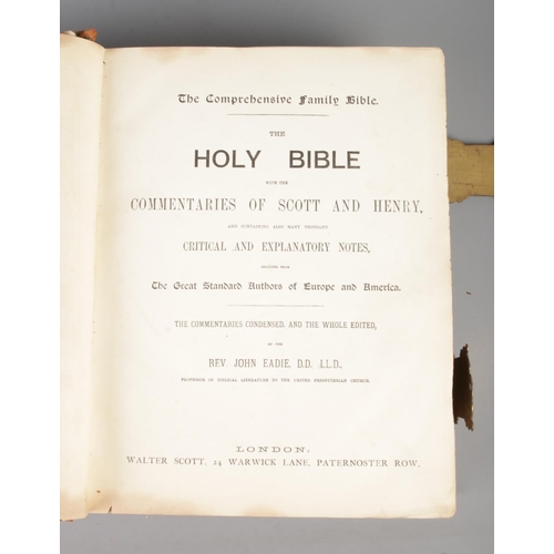 57 - An antique leather bound Holy Bible, with brass clasps and coloured plates. The Comprehensive Family... 