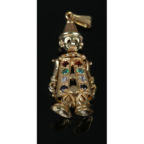 382 - A 9ct Gold charm formed as a clown, with gem set body. Length: 35mm. Total weight: 2.9g