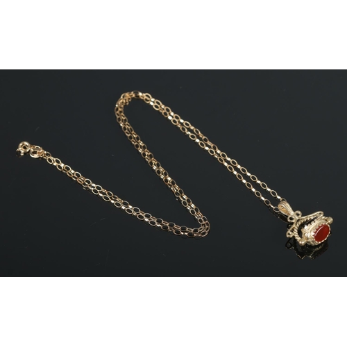 389 - A 9ct Gold three stone swivel fob, on 9ct Gold chain. Total weight: 4.1g.