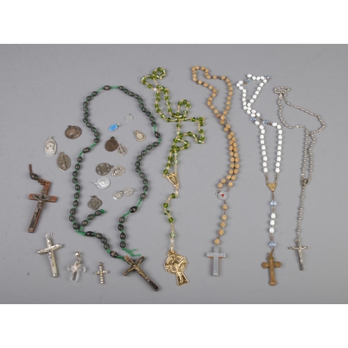 396 - A collection of five rosary bead necklaces and crosses