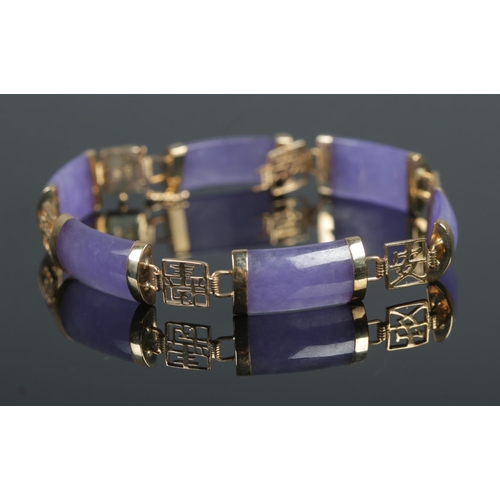 397 - A 9ct Gold and 'Lavender Jade' coloured bracelet, set with six pieces between pierced Oriental chara... 