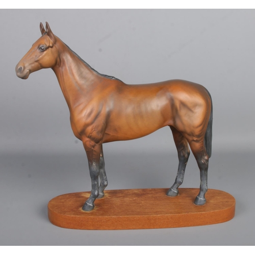 415 - A Beswick ceramic horse, modelled on the racehorse 'Arkle', champion steeplechaser. Mounted on woode... 