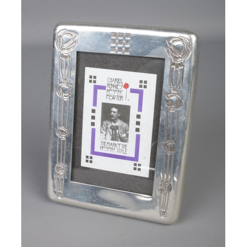 418 - A Charles Rennie Mackintosh pewter photo frame decorated with two columns of roses. Approx. size 10c... 