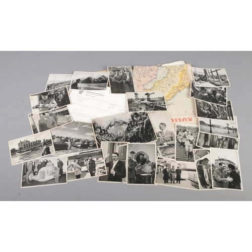 454 - A collection of WW2 photos of Adolf Hitler together with a Russo-German war map, the photos are acco... 