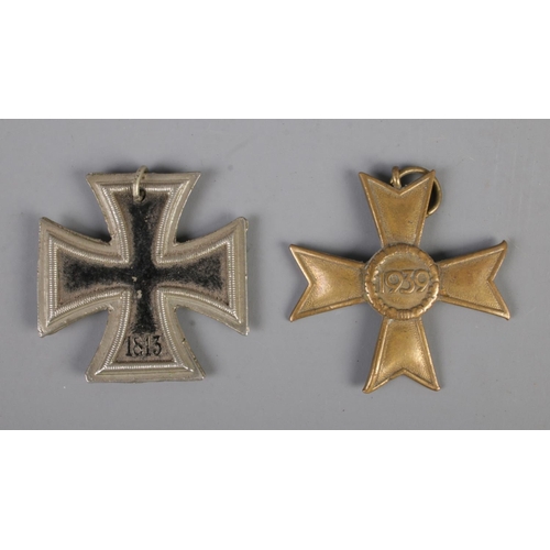 465 - A WW2 German war merit medal 2nd class together with an iron cross