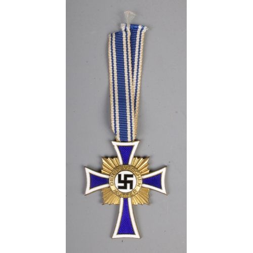 469 - German WW2 Cross Of Honour Of The German Mother Gold with ribbon. This award was instituted on 16 De... 