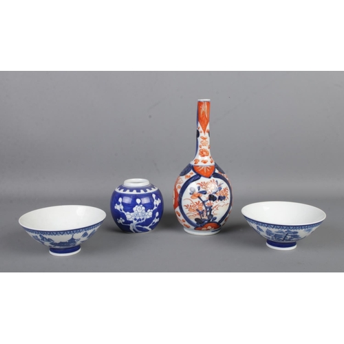 83 - A collection of oriental ceramics to include Imari bottle vase, pair of tea bowls and small ginger j... 