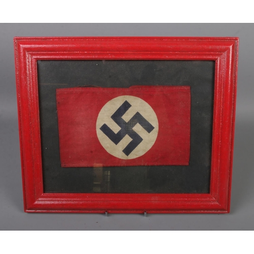 488 - A WW2 Nazi armband, with applied printed swastika in frame.