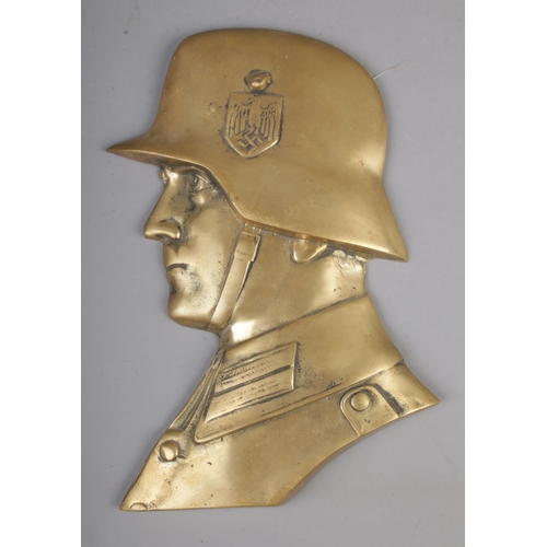 491 - A cast brass relief of a German WW2 soldier.