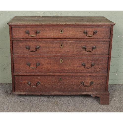 500 - A Georgian oak small chest of four drawers featuring brass swan neck handles and escutcheons. Approx... 