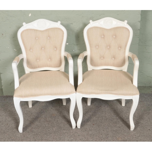 501 - A pair of modern The Grand Louis chairs featuring beige button upholstered  back and seat.