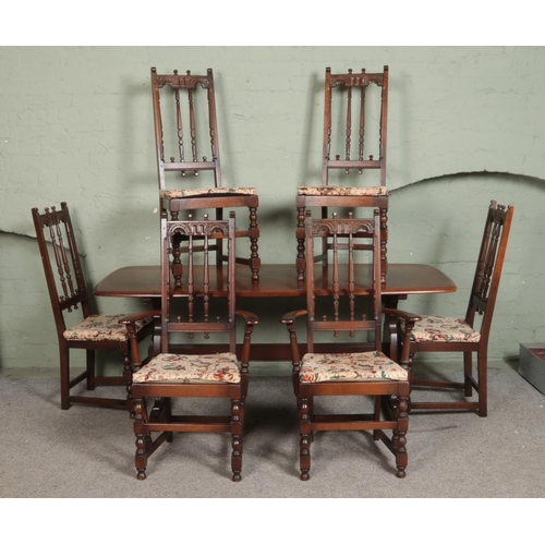 503 - An Ercol 'Old Colonial' refectory table and set of six chairs including two carver examples. Approx.... 