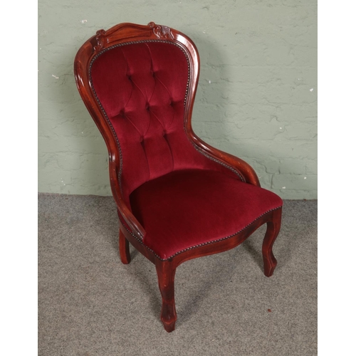 504 - A spoon back bedroom chair featuring deep button red velvet upholstery.