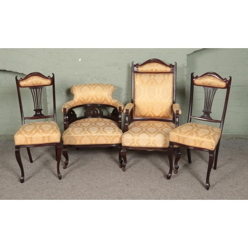 505 - A Victorian carved mahogany four piece salon suite to include upholstered captains chair.