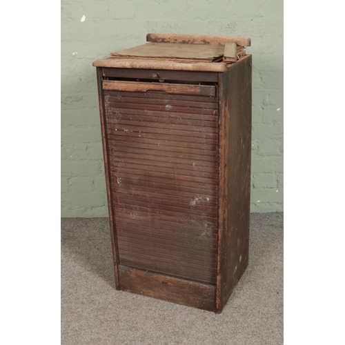 506 - An oak tambour fronted nine drawer filing cabinet. Approx. dimensions 48cm x 40cm x 93cm.