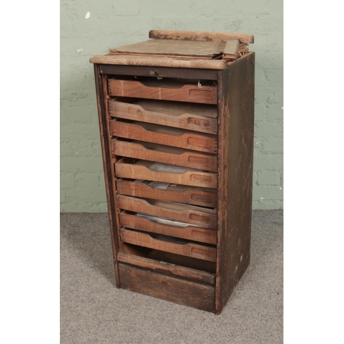 506 - An oak tambour fronted nine drawer filing cabinet. Approx. dimensions 48cm x 40cm x 93cm.