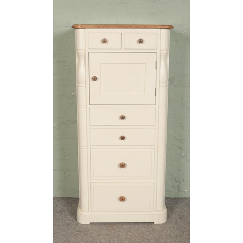 507 - A Laura Ashley pine and oak cream painted tall boy, with six drawers and cupboard door. Height: 136c... 